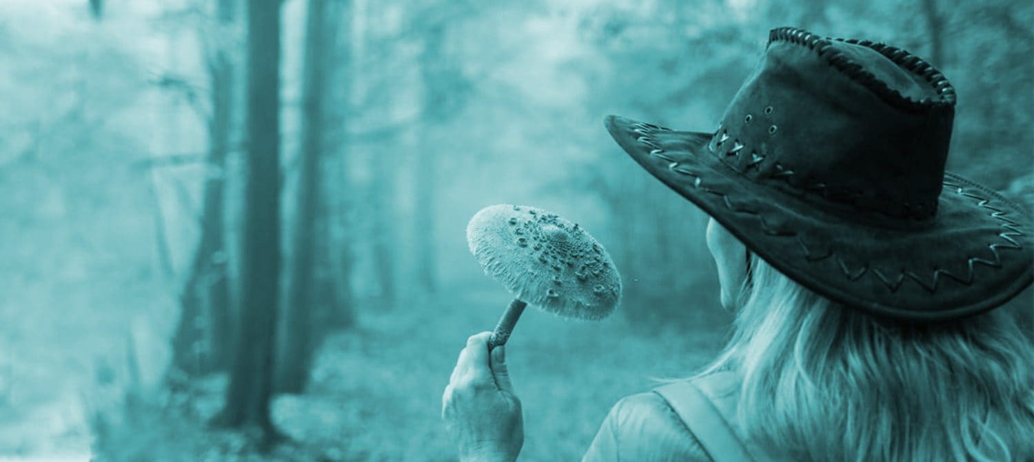 Girl smelling a fresh mushroom